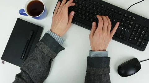 Man typing text on a keyboard on a white table. Top view Stock Footage 101839400