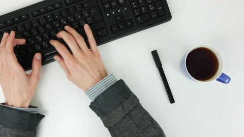 Man typing text on a keyboard on a white table. Top view Stock Footage 101839645
