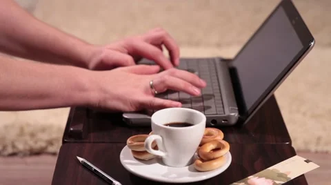 A man is typing text on laptop and drinking coffee Stock Footage 58395410