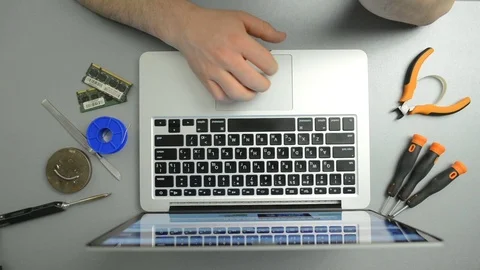 Man typing text on the laptop keyboard in the service center Stock Footage 73601205
