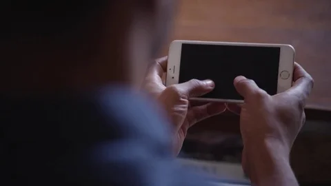 Man typing text message on mobile phone at home Stock Footage 83185146