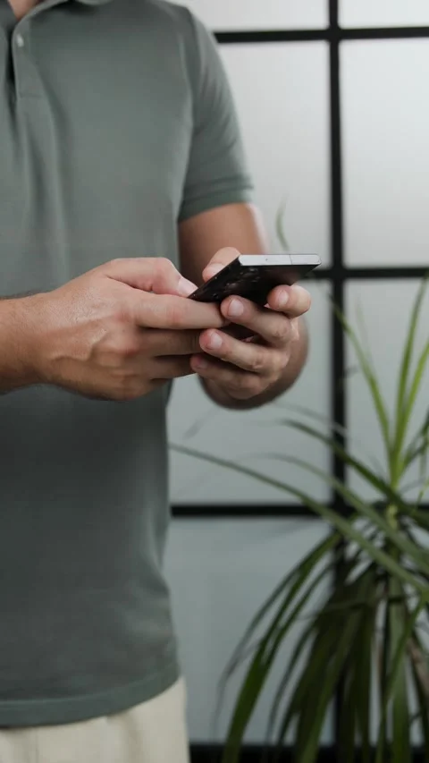 Man Typing Text Message on Smartphone at Home Video stock 343450449