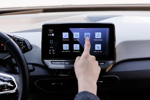 Man typing touchscreen inside his auto. Man sitting in front of the handlebar of Stock Photos