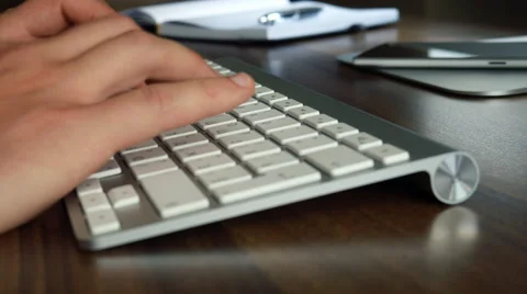 Man typing on white keyboard Stock Footage 64622573