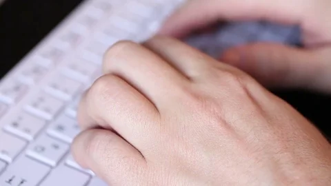 Man typing on a white keyboard. hands closeup Stock Footage 72560458