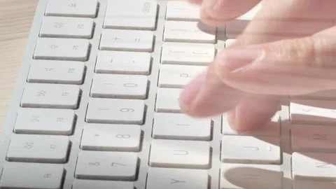 A man is typing on a wireless keyboard . close up . Stockbeeldmateriaal 136385148