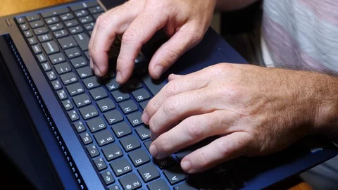 Man typing, working on laptop computer at a desk, 4k, 60fps. Stock Footage 116336148