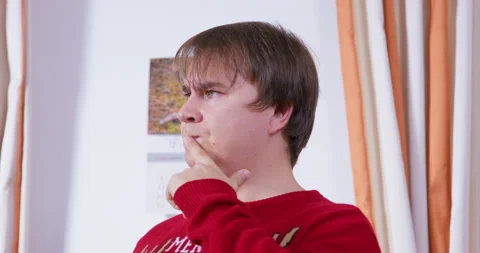 Man in ugly sweater looks puzzled, thinks solves difficult problem. Gift choice Stock Footage 244614205