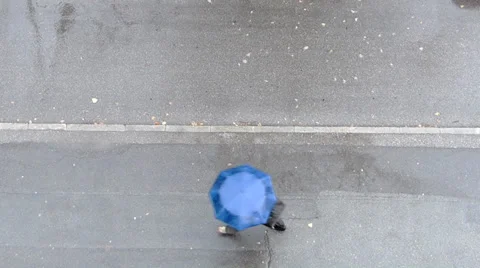 Man with umbrella passing by. View from above. 2 Stock Footage 34832662