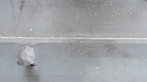 Man with umbrella passing by. View from above. 3 Stock Footage 34833221