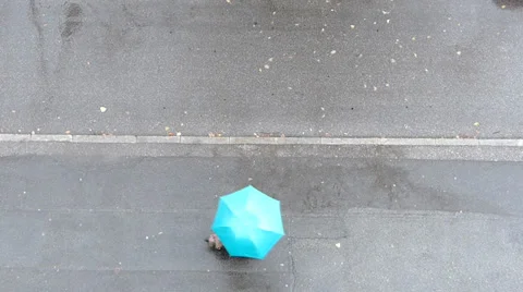 Man with umbrella passing by. View from above. Stock Footage 34833269