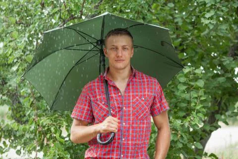 Man with umbrella in rain Stock Photos