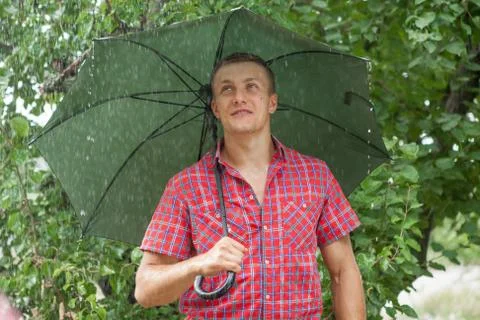 Man with umbrella in rain Stock Photos