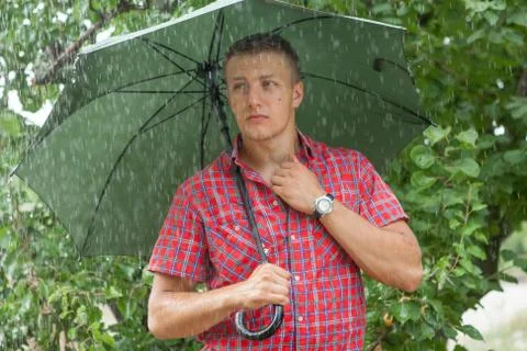 Man with umbrella in rain Stock Photos