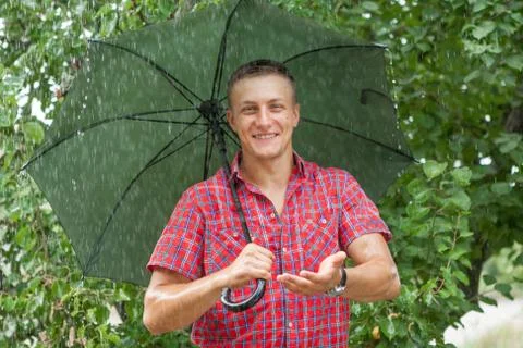 Man with umbrella in rain Stock Photos