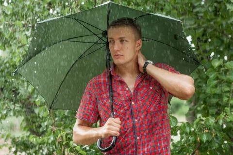 Man with umbrella in rain Stock Photos