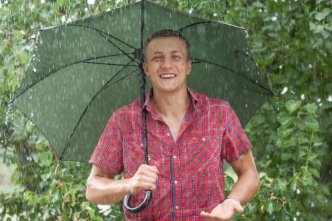 Man with umbrella in rain Stock Photos