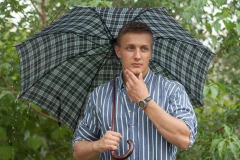 Man with umbrella in rain Stock Photos