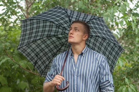 Man with umbrella in rain Stock Photos