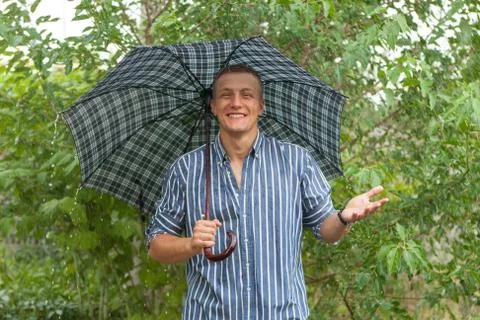 Man with umbrella in rain Stock Photos
