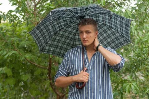 Man with umbrella in rain Stock Photos