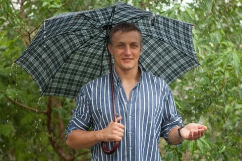 Man with umbrella in rain Stock Photos