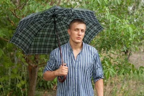 Man with umbrella in rain Stock Photos