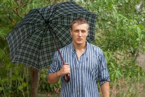 Man with umbrella in rain Stock Photos