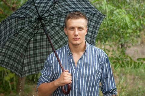 Man with umbrella in rain Stock Photos