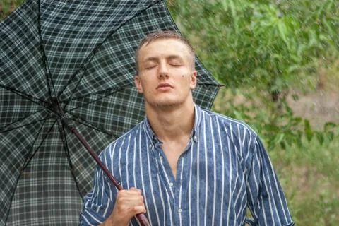 Man with umbrella in rain Stock Photos
