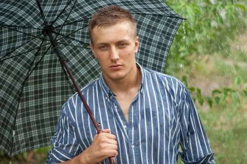 Man with umbrella in rain Stock Photos
