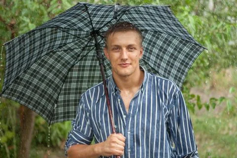 Man with umbrella in rain Stock Photos