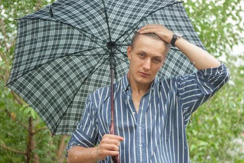 Man with umbrella in rain Stock Photos