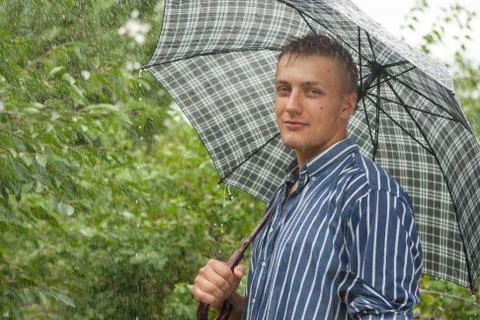 Man with umbrella in rain Stock Photos