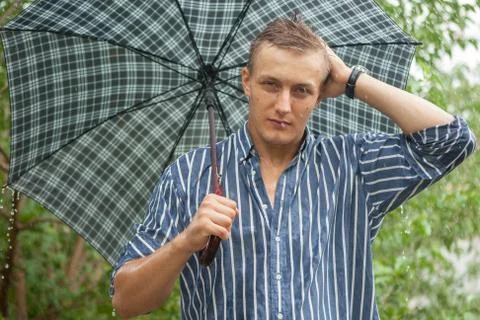 Man with umbrella in rain Stock Photos