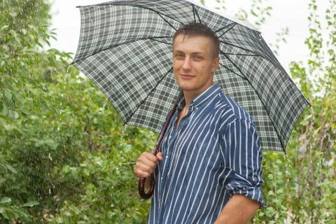 Man with umbrella in rain Stock Photos