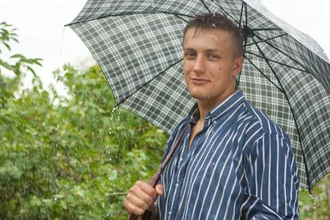 Man with umbrella in rain Stock Photos