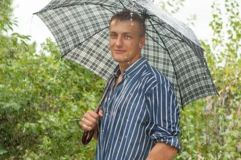 Man with umbrella in rain Stock Photos