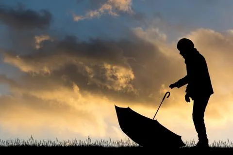 Man with umbrella at sunset Stock Illustration