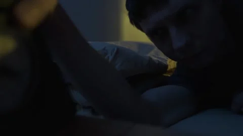 Man unable to sleep at night looking at clock showing late hour, insomnia and Stock Footage 321005079