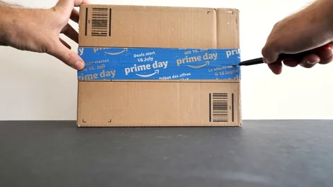 Man unboxing Amazon Prime Day cardboard parcel Stock Footage 95207985