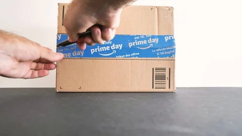 Man unboxing Amazon Prime Day cardboard parcel Stock Footage 95207998
