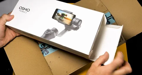 Man unboxing DJI Osmo 2 smartphone gimbal Video stock 100820958
