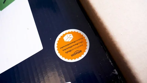 Man unboxing large cardboard box containing Italian DeLonghi convection heater Stock Footage 85911764