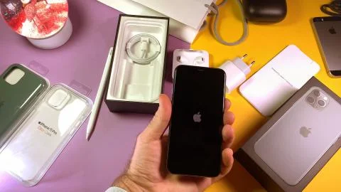 Man unboxing latgest Apple Computers iPhone 11 Pro Stock Photos