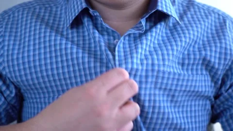 A man unbuttoned his shirt because the office was hot Stock Footage 165835302