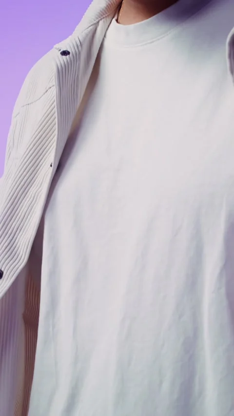 Man unbuttoning shirt buttons posing in studio vertical - Men. Video stock 323974068