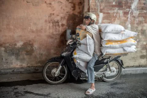Man under bridge with lots of bags on his motorcycle Stock Photos