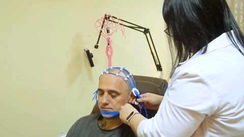 A man undergoes an electroencephalogram (EEG) 스톡 동영상 321609350