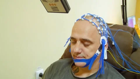 A man undergoes an electroencephalogram (EEG) Видео 321609390